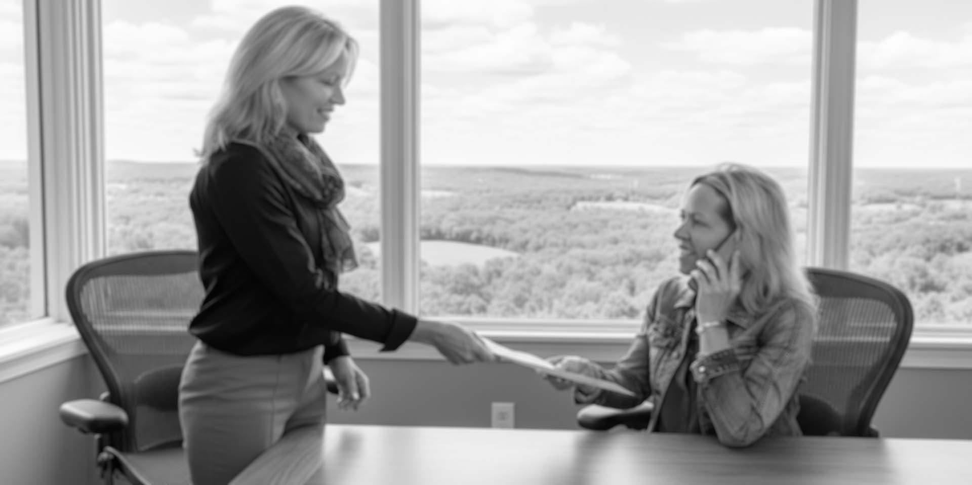 Quinn staff handing paperwork to a new hire
